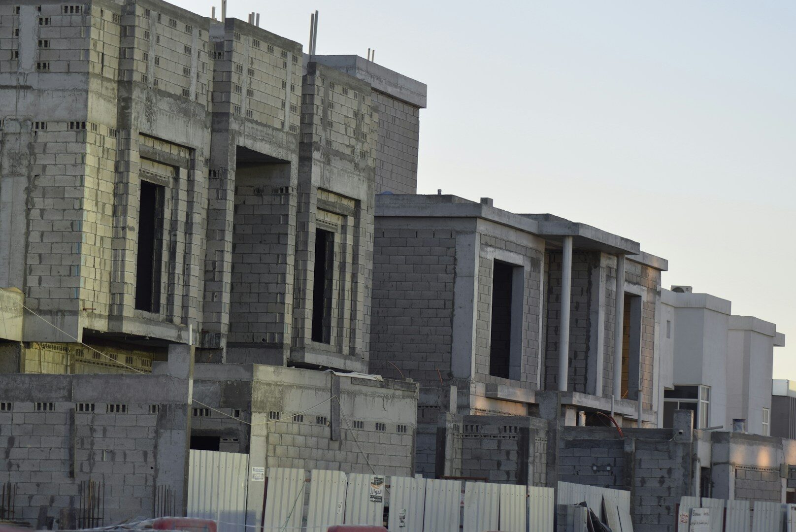 Row of houses under construction against sky