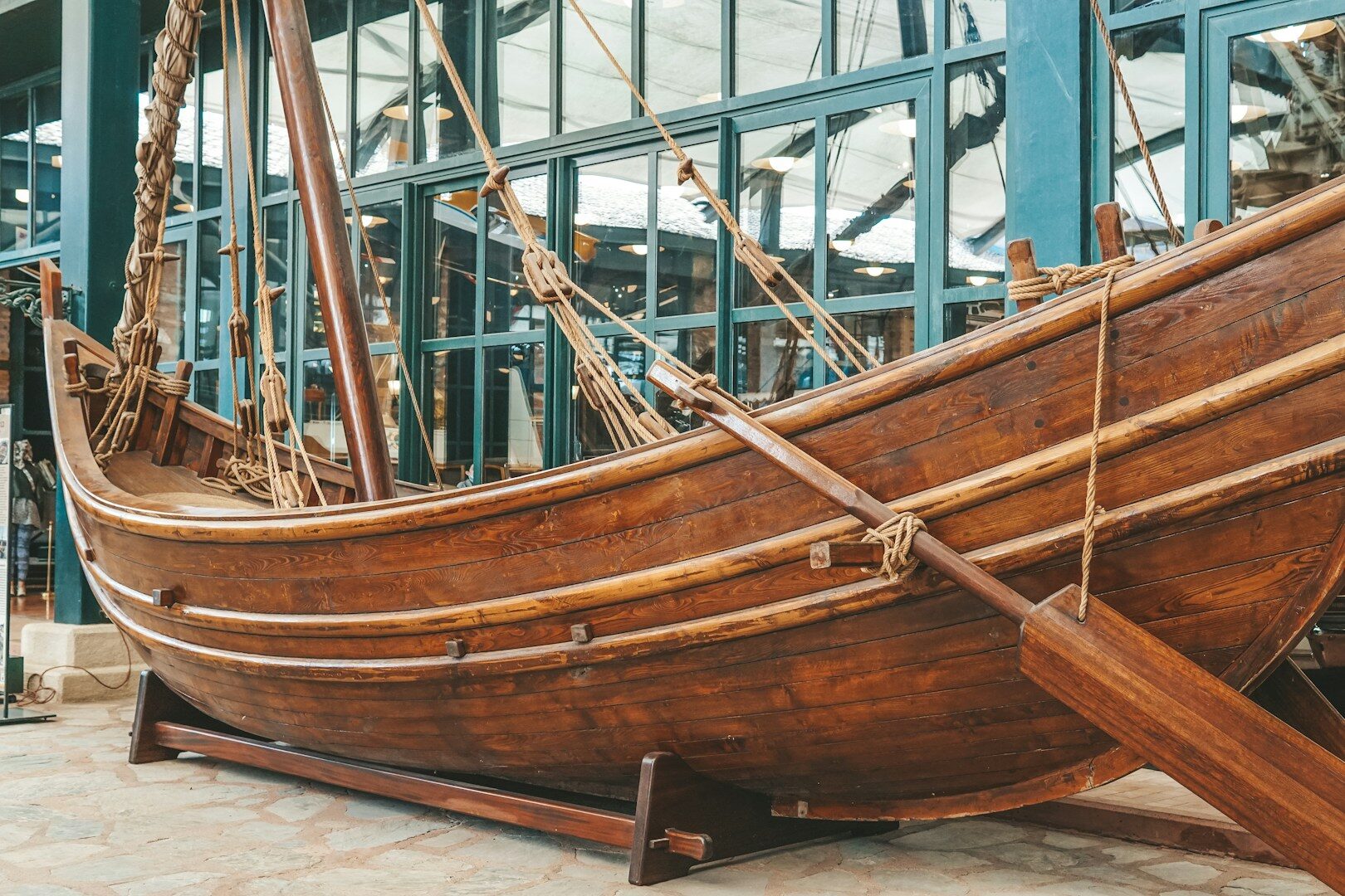 a large wooden boat on display in front of a building
