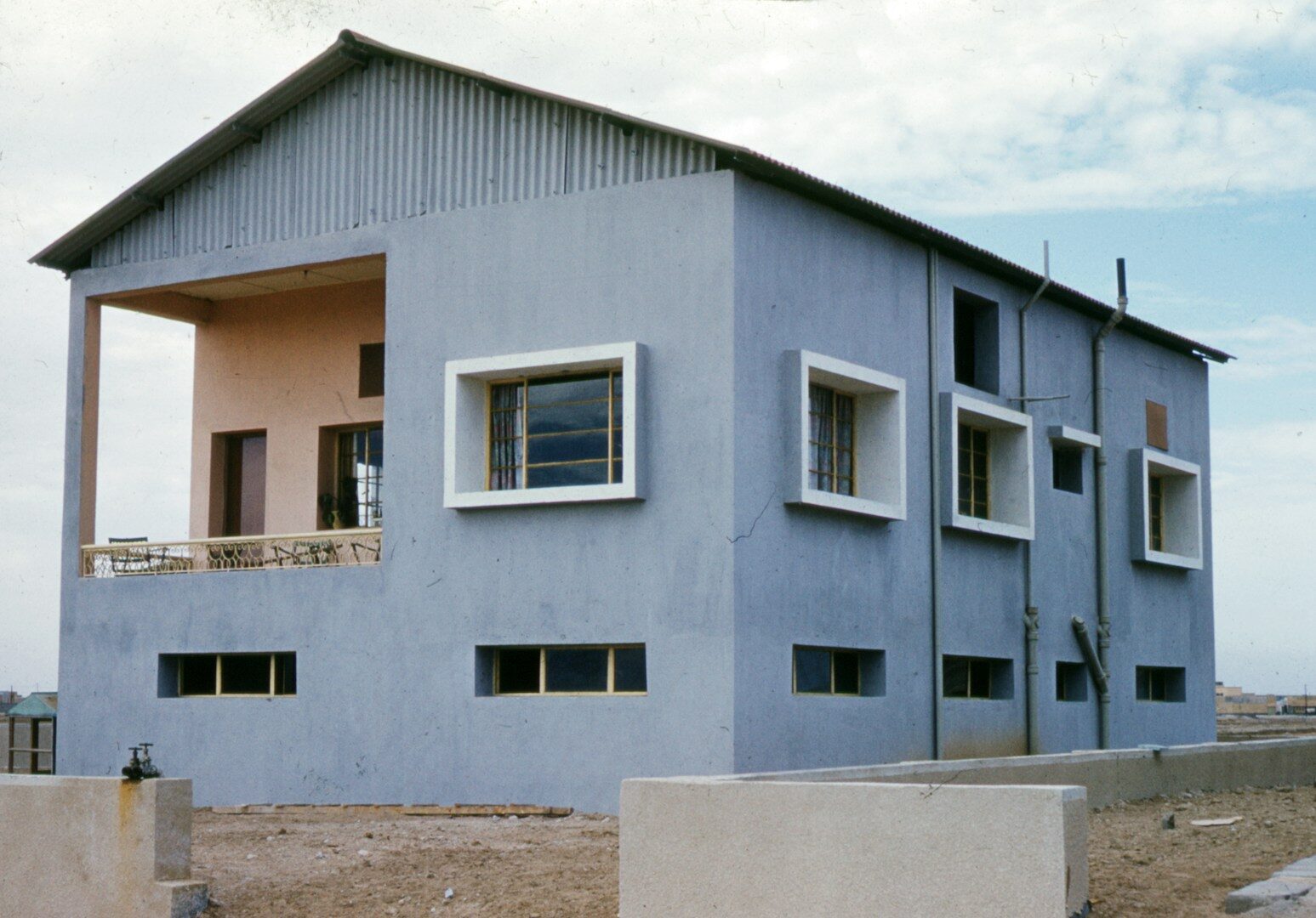 blue concrete building under white clouds during daytime